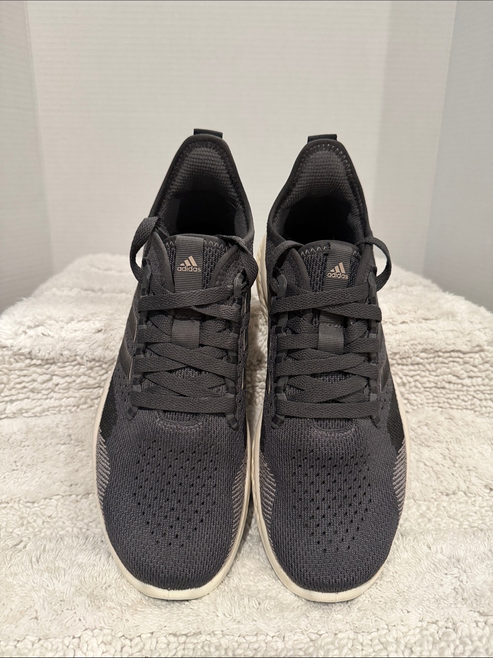 Adidas Performance Ultrabounce sneakers in a dark grey and white colorway.